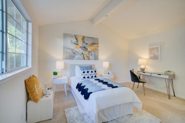 a bedroom with furniture and a window