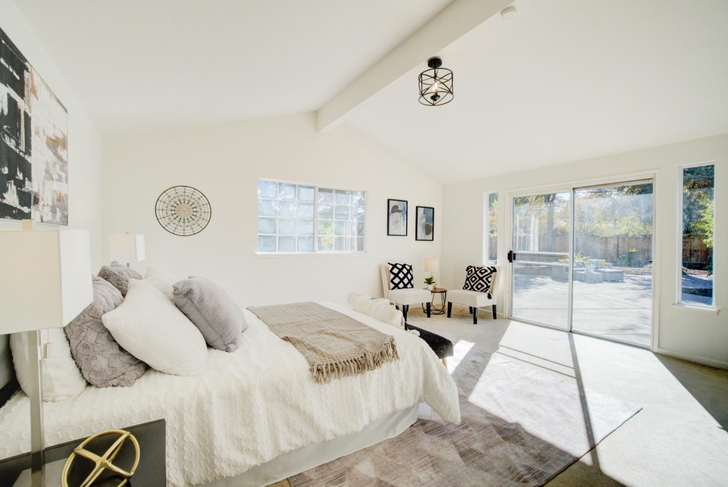 18444 Purdue Drive Saratoga, CA 95070 - Photo 22 of 31 a bedroom with a large bed and a chandelier