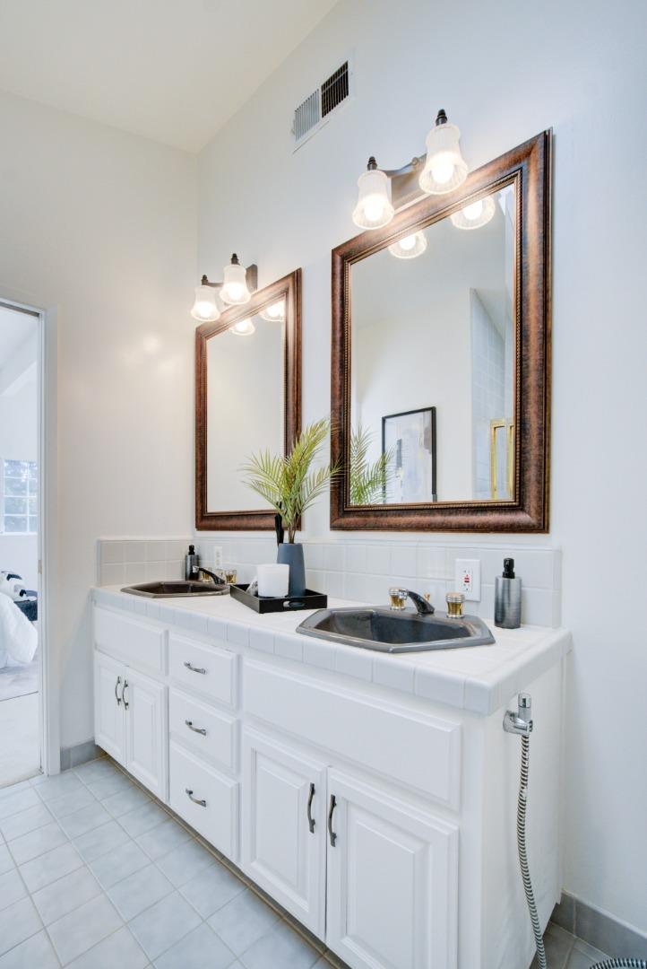 18444 Purdue Drive Saratoga, CA 95070 - Photo 25 of 31 a bathroom with a double vanity sink and a mirror
