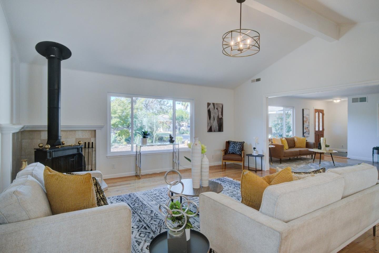 18444 Purdue Drive Saratoga, CA 95070 - Photo 7 of 31 a living room with furniture a window and a chandelier