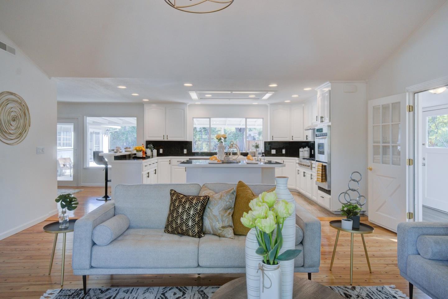 18444 Purdue Drive Saratoga, CA 95070 - Photo 8 of 31 a living room with furniture a rug kitchen view and a chandelier