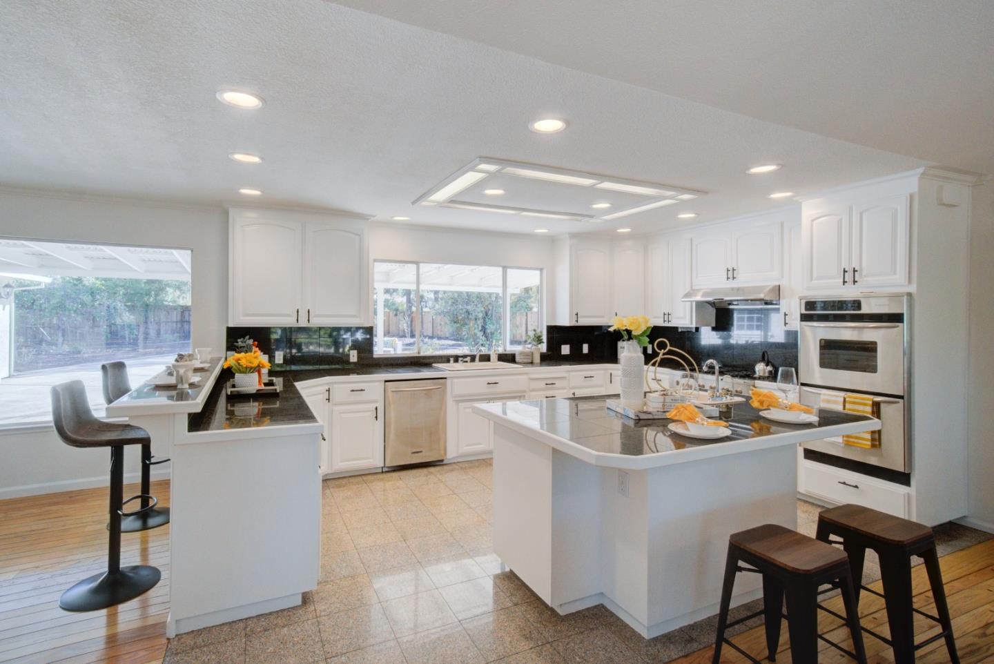 18444 Purdue Drive Saratoga, CA 95070 - Photo 9 of 31 a kitchen that has a lot of cabinets in it and appliances