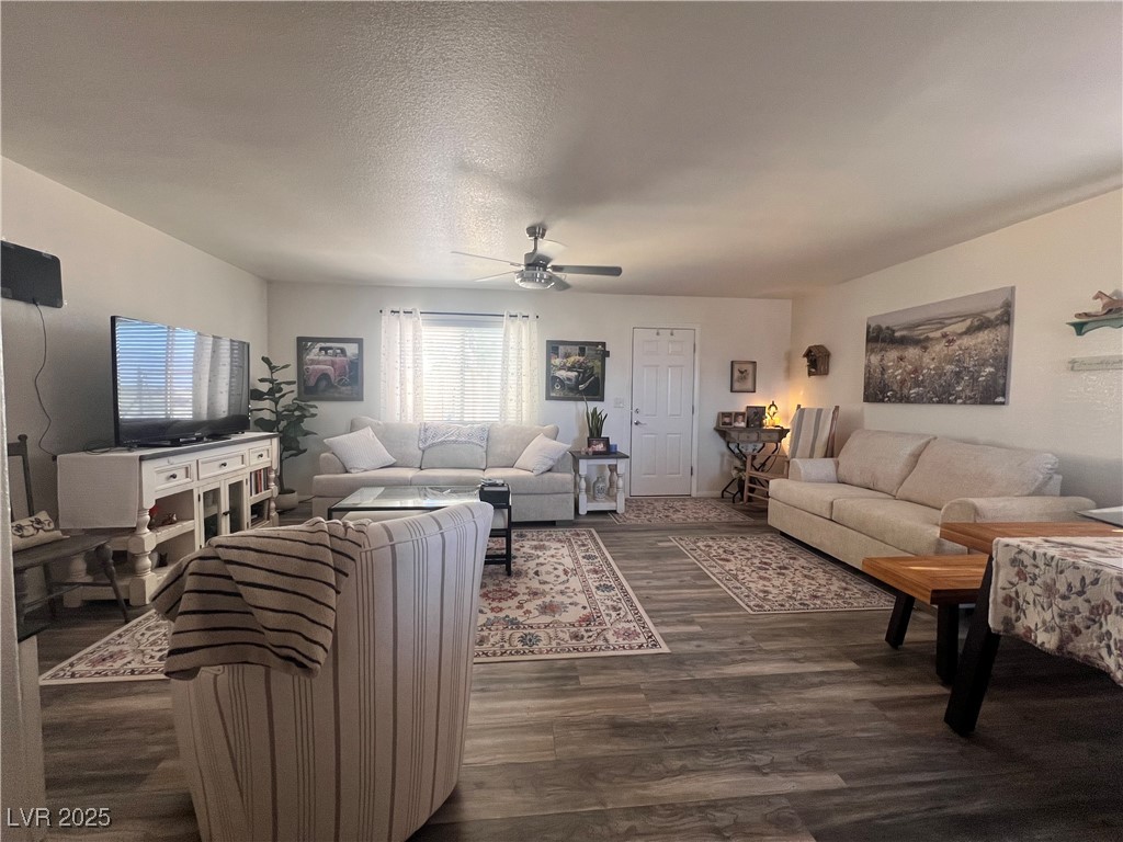2970 Rio Rico Drive Pahrump, NV 89048 - Photo 11 of 53 Living area with ceiling fan, a textured ceiling, and dark wood-type flooring