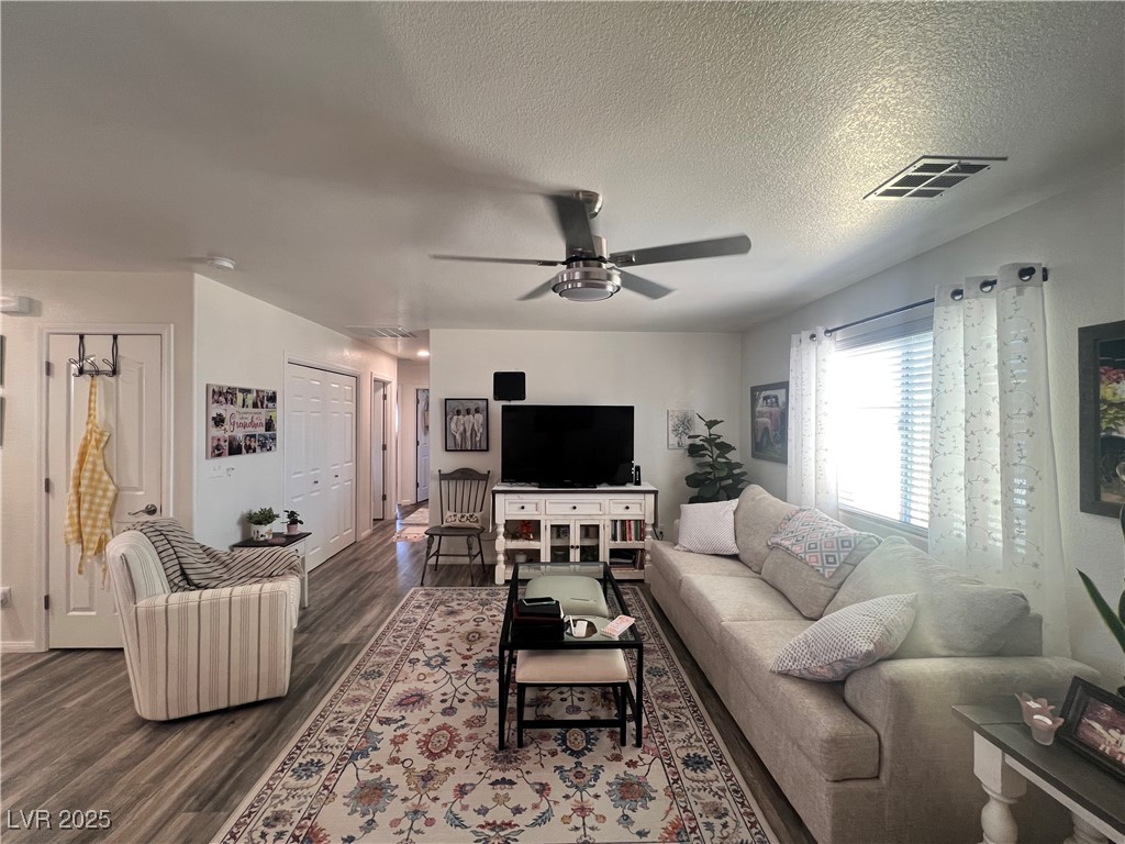 2970 Rio Rico Drive Pahrump, NV 89048 - Photo 14 of 53 Living room with ceiling fan, a textured ceiling, and dark wood finished floors