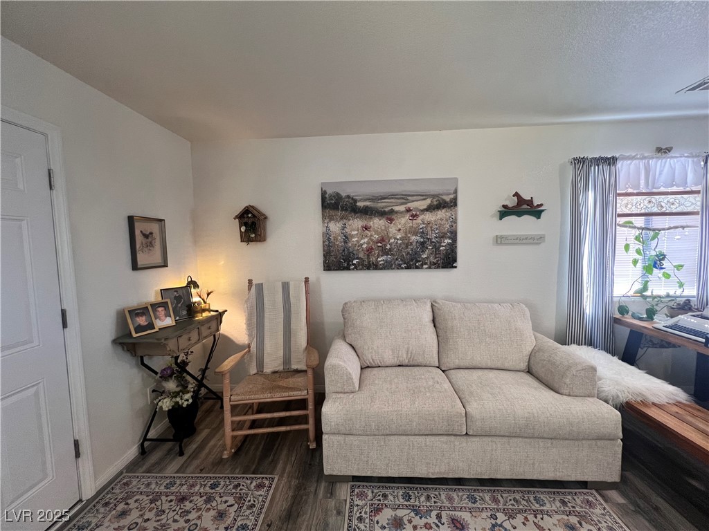 2970 Rio Rico Drive Pahrump, NV 89048 - Photo 18 of 53 Living room featuring dark wood finished floors and baseboards