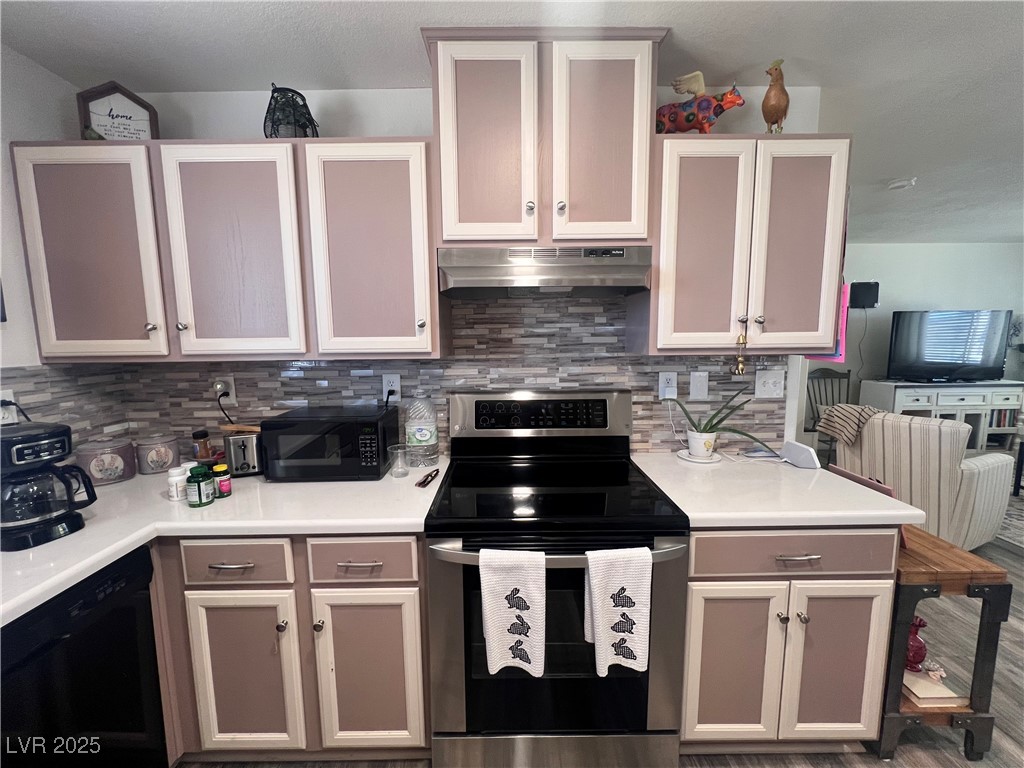 2970 Rio Rico Drive Pahrump, NV 89048 - Photo 20 of 53 Kitchen featuring black appliances, backsplash, under cabinet range hood, and light countertops