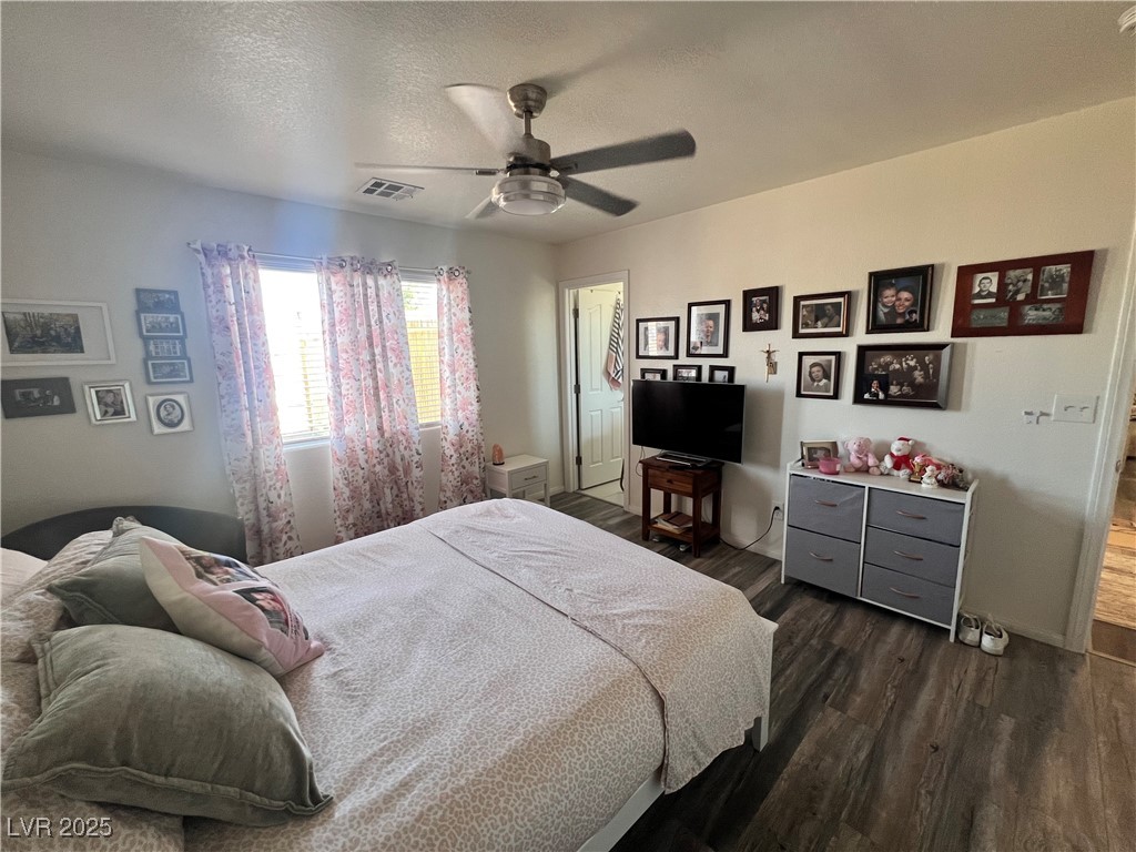 2970 Rio Rico Drive Pahrump, NV 89048 - Photo 28 of 53 Primary Bedroom featuring dark wood-style flooring, a textured ceiling, and ceiling fan
