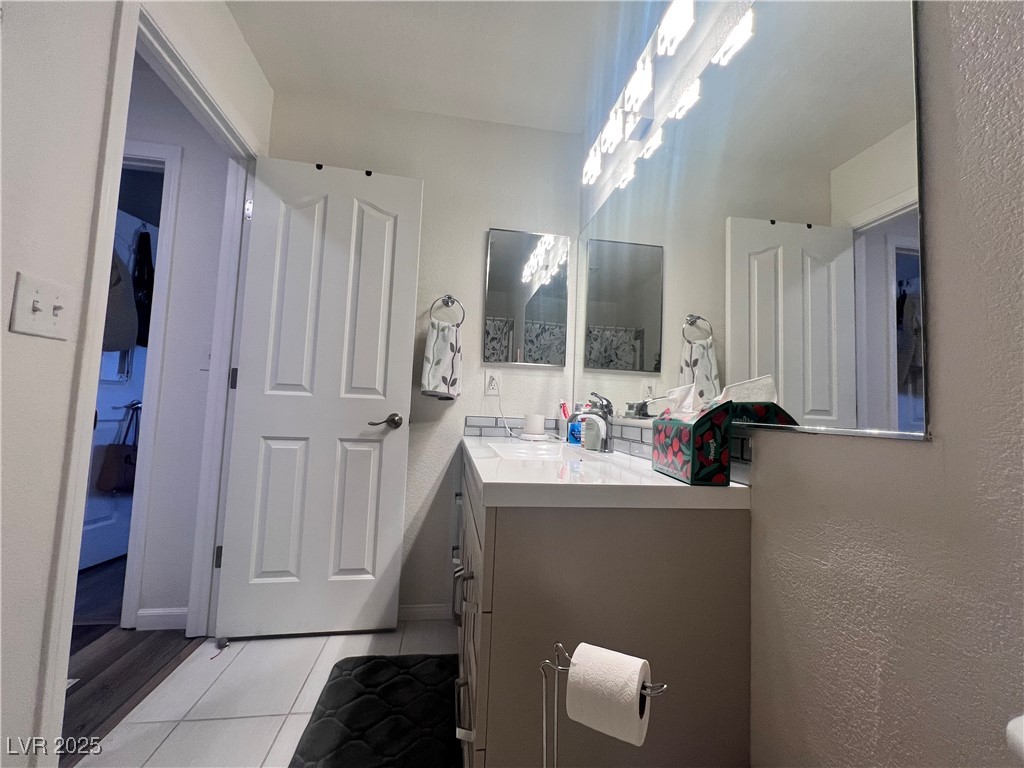 2970 Rio Rico Drive Pahrump, NV 89048 - Photo 38 of 53 Bathroom with vanity, a textured wall, and tile patterned flooring