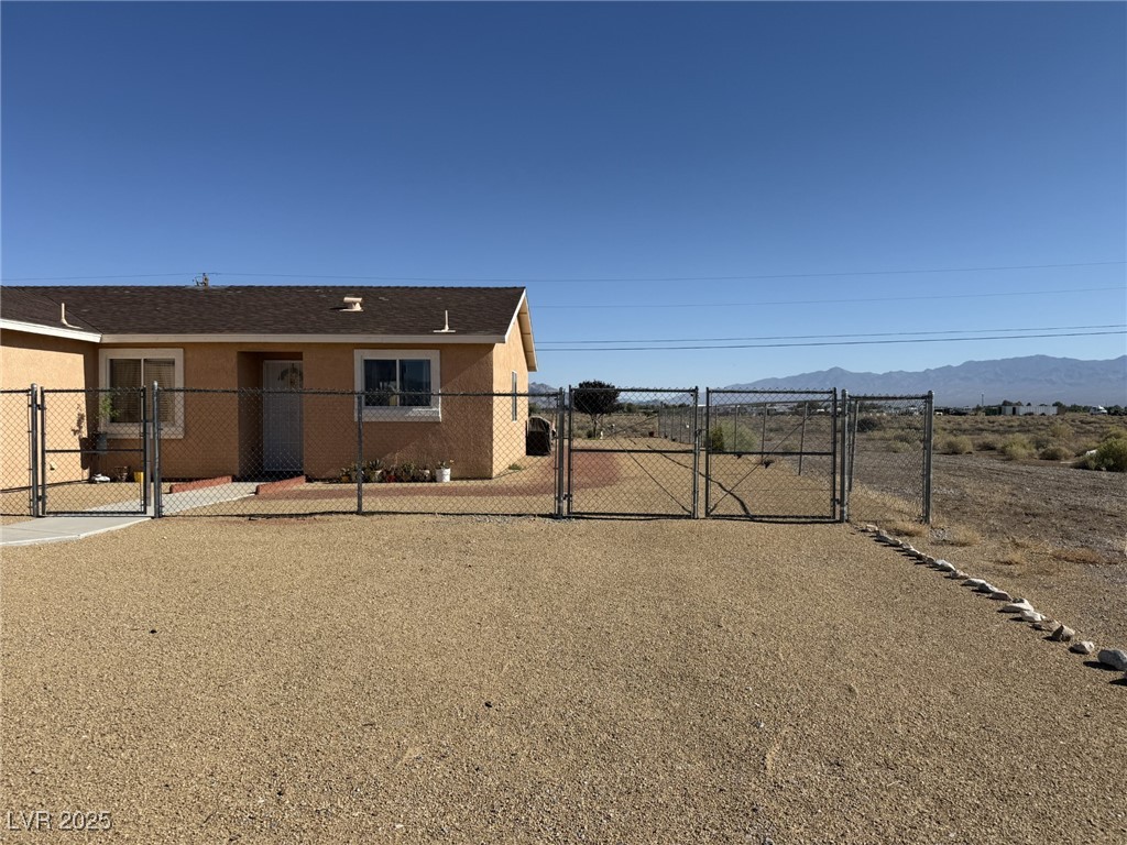 2970 Rio Rico Drive Pahrump, NV 89048 - Photo 4 of 53 View of front of home featuring a gate and stucco siding