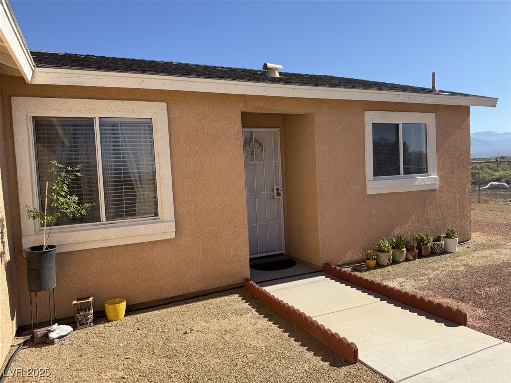 2970 Rio Rico Drive Pahrump, NV 89048 - Photo 5 of 53 View of exterior entry featuring stucco siding
