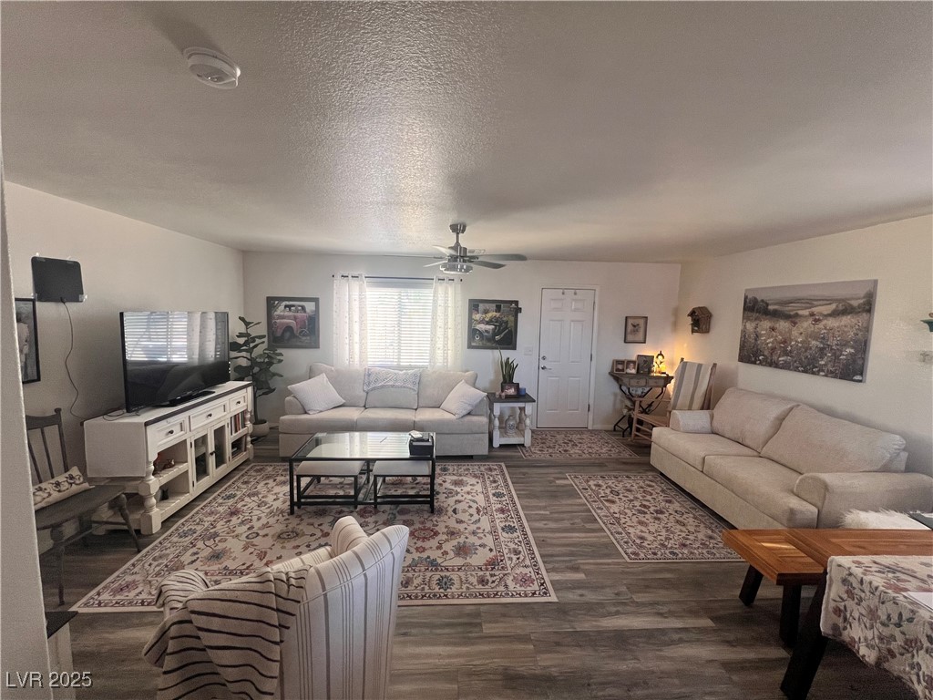 2970 Rio Rico Drive Pahrump, NV 89048 - Photo 10 of 53 Living room featuring a ceiling fan, wood finished floors, and a textured ceiling