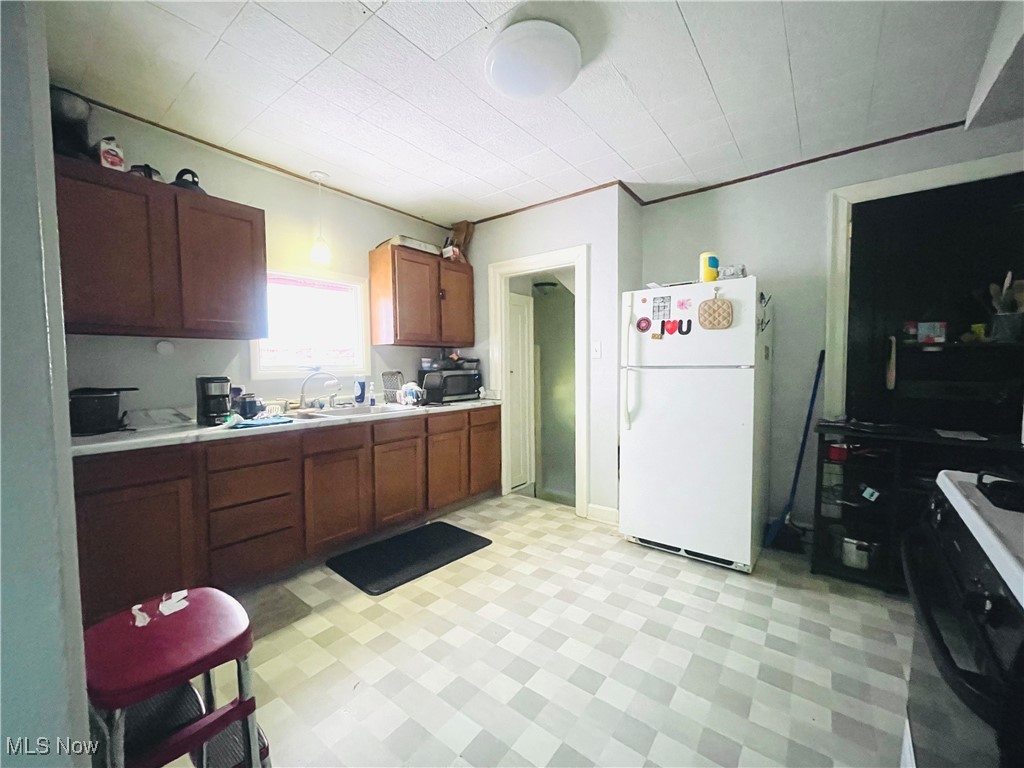 2409 Lake Rd Boulevard Northwest Canton, OH 44708 - Photo 5 of 21 Kitchen featuring sink and white fridge