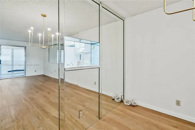a view of a room with wooden floor