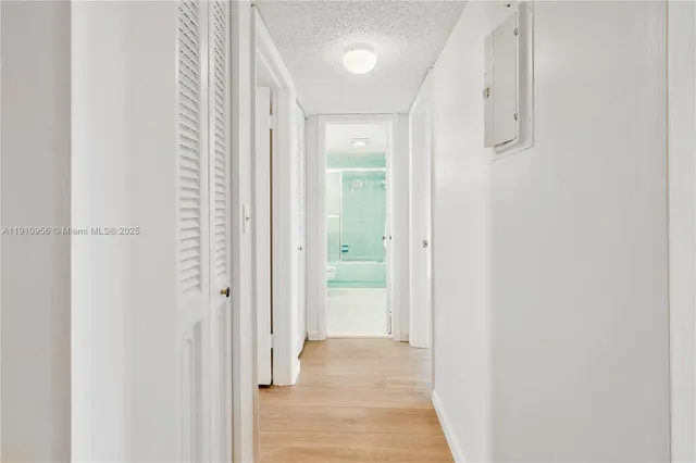 a view of a hallway with wooden floor