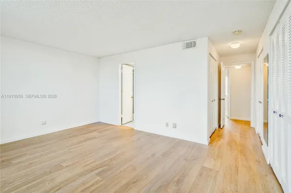 a view of a room with wooden floor
