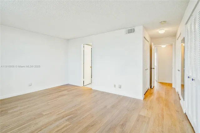 a view of a room with wooden floor