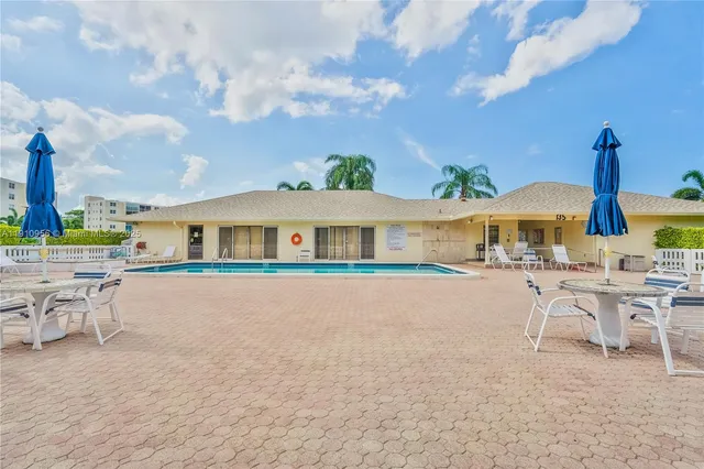 a front view of house with a garden and patio