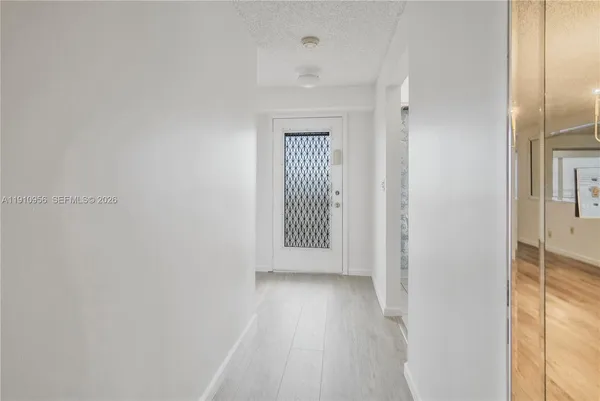 a view of a hallway with wooden floor