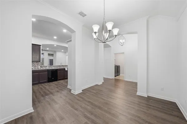 a view of a kitchen with a sink and stainless steel appliances