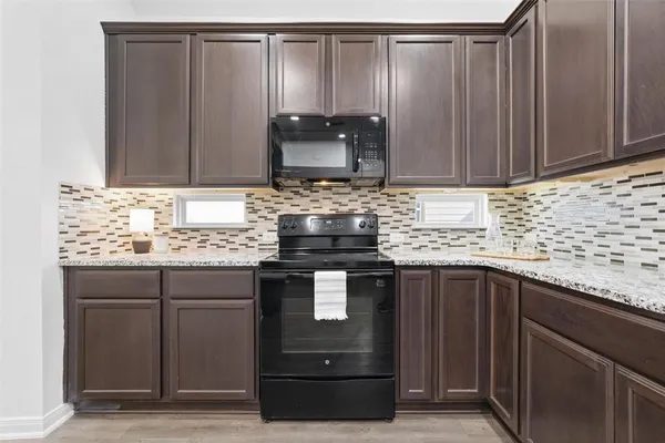 a kitchen with granite countertop cabinets and sink