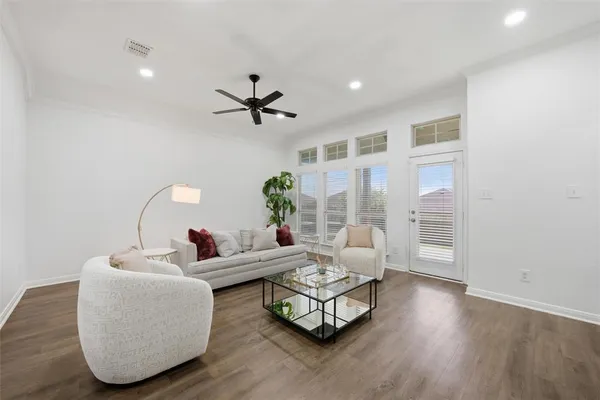 a living room with furniture and wooden floor