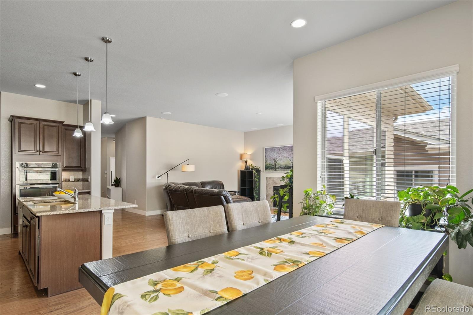 17670 West 94th Drive Arvada, CO 80007 - Photo 18 of 49 a living room with kitchen island granite countertop furniture and a table