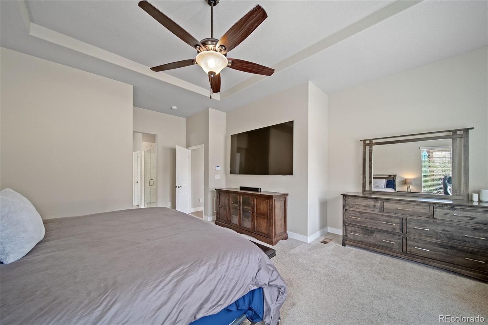 17670 West 94th Drive Arvada, CO 80007 - Photo 22 of 49 a bedroom with a large bed and a flat screen tv