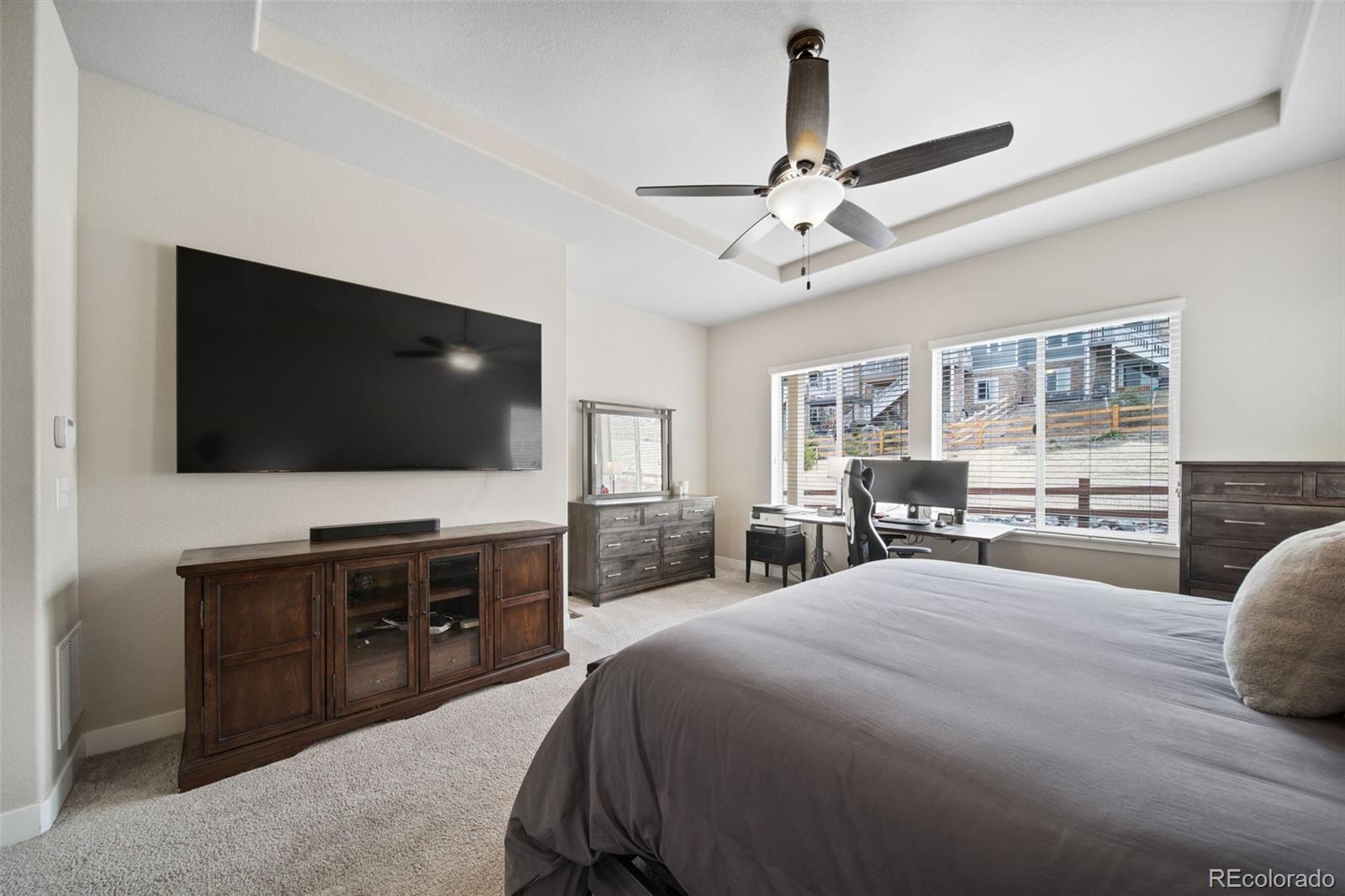 17670 West 94th Drive Arvada, CO 80007 - Photo 23 of 49 a bedroom with a bed and a flat screen tv