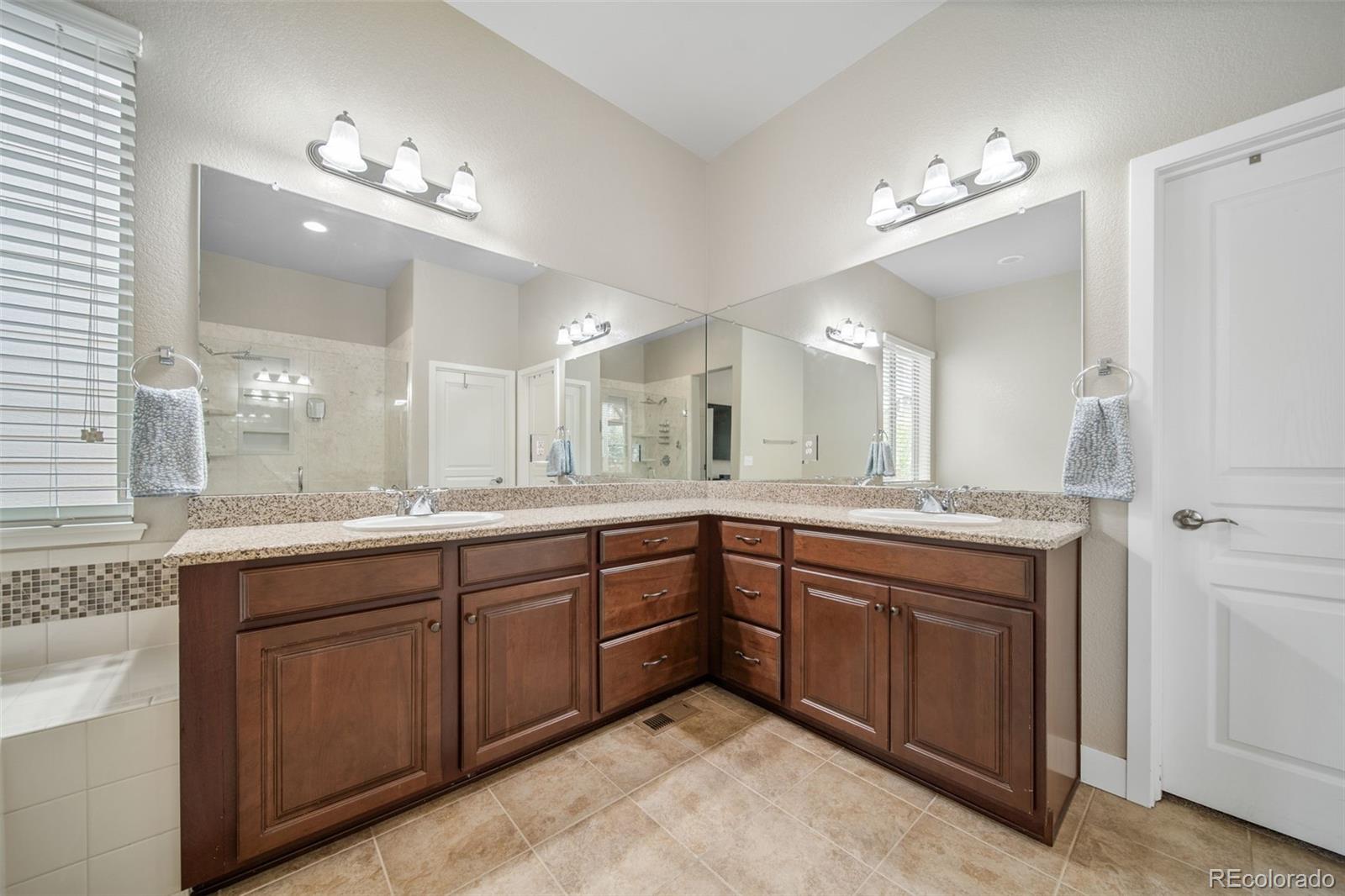 17670 West 94th Drive Arvada, CO 80007 - Photo 24 of 49 a bathroom with a sink vanity and a mirror