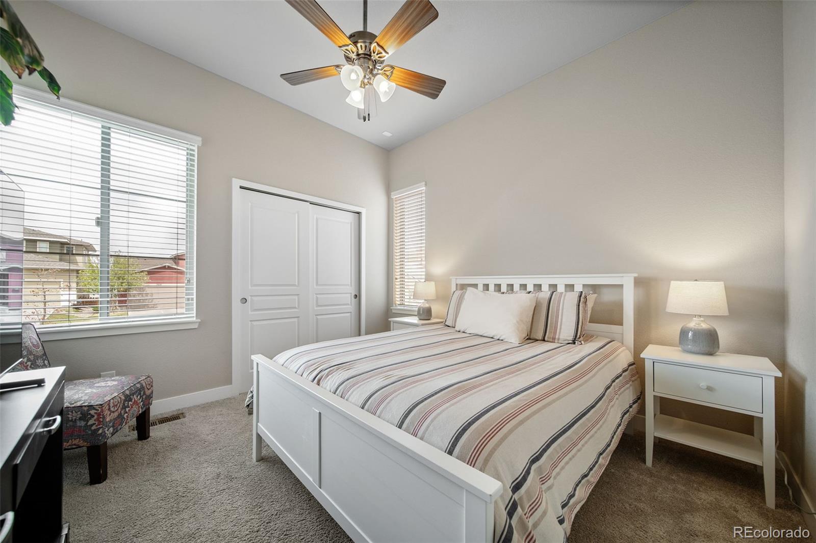 17670 West 94th Drive Arvada, CO 80007 - Photo 27 of 49 a bedroom with a bed and a chandelier