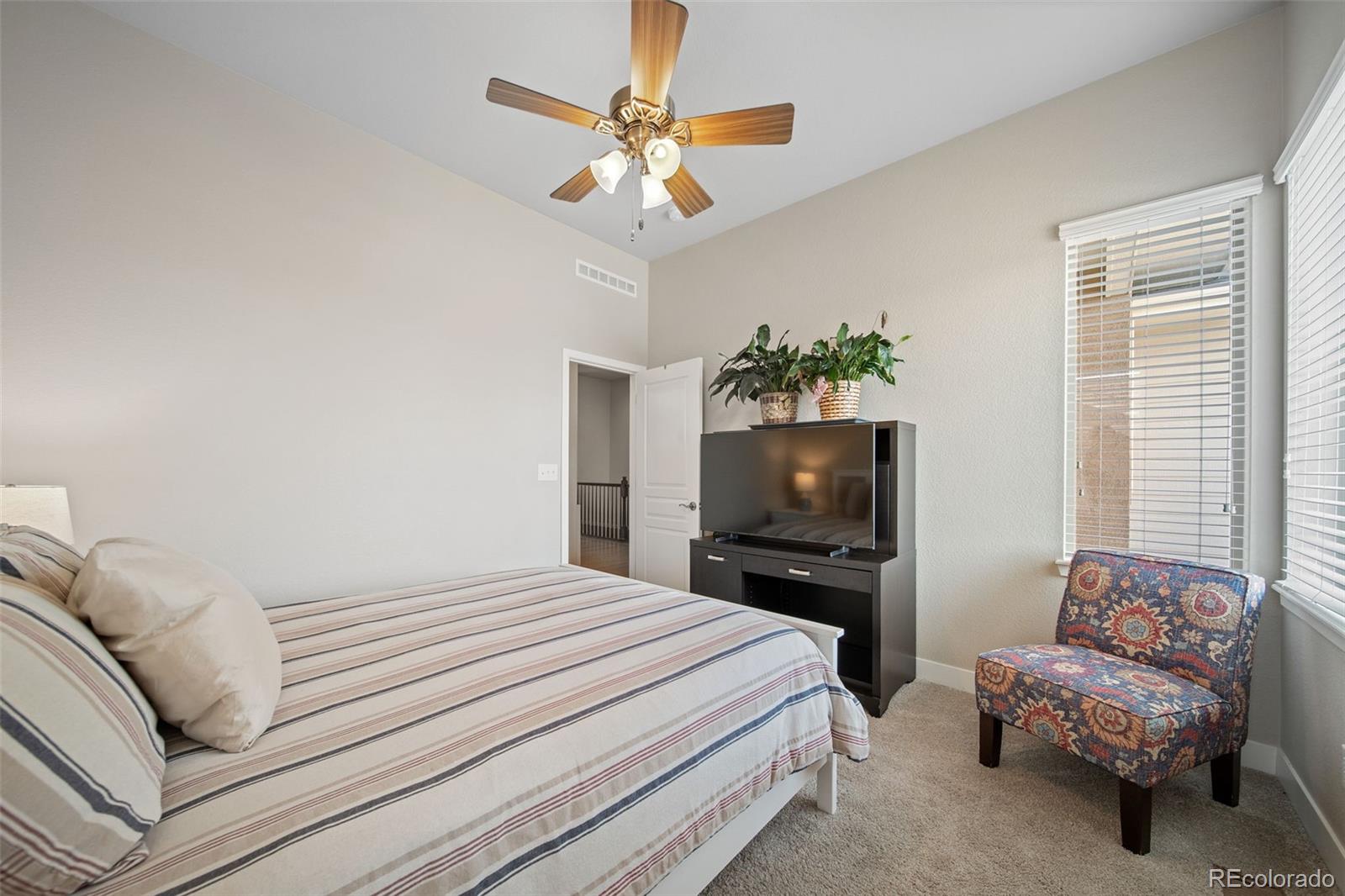 17670 West 94th Drive Arvada, CO 80007 - Photo 28 of 49 a bedroom with a bed and a television