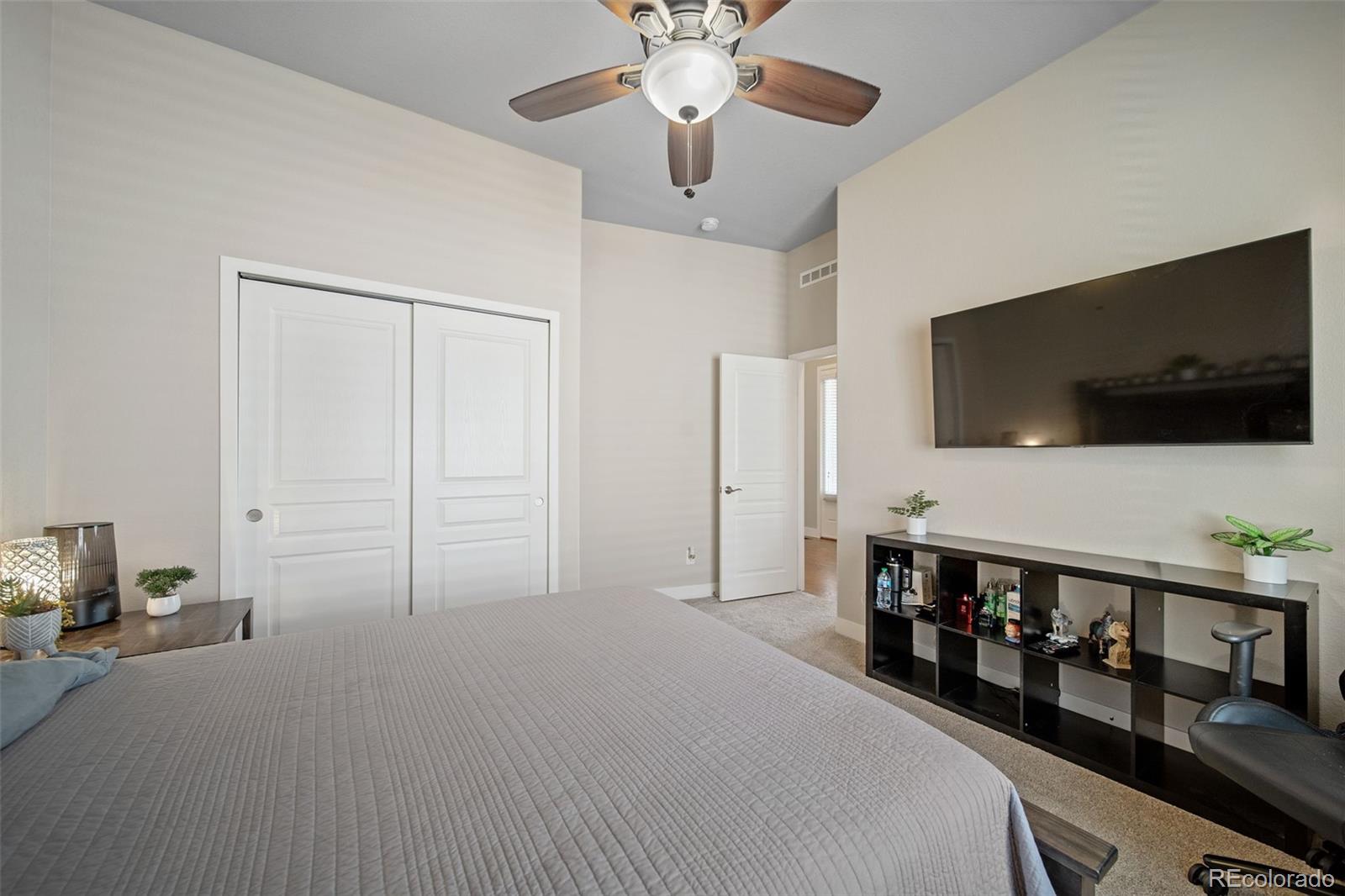 17670 West 94th Drive Arvada, CO 80007 - Photo 31 of 49 a bedroom with furniture and a flat screen tv