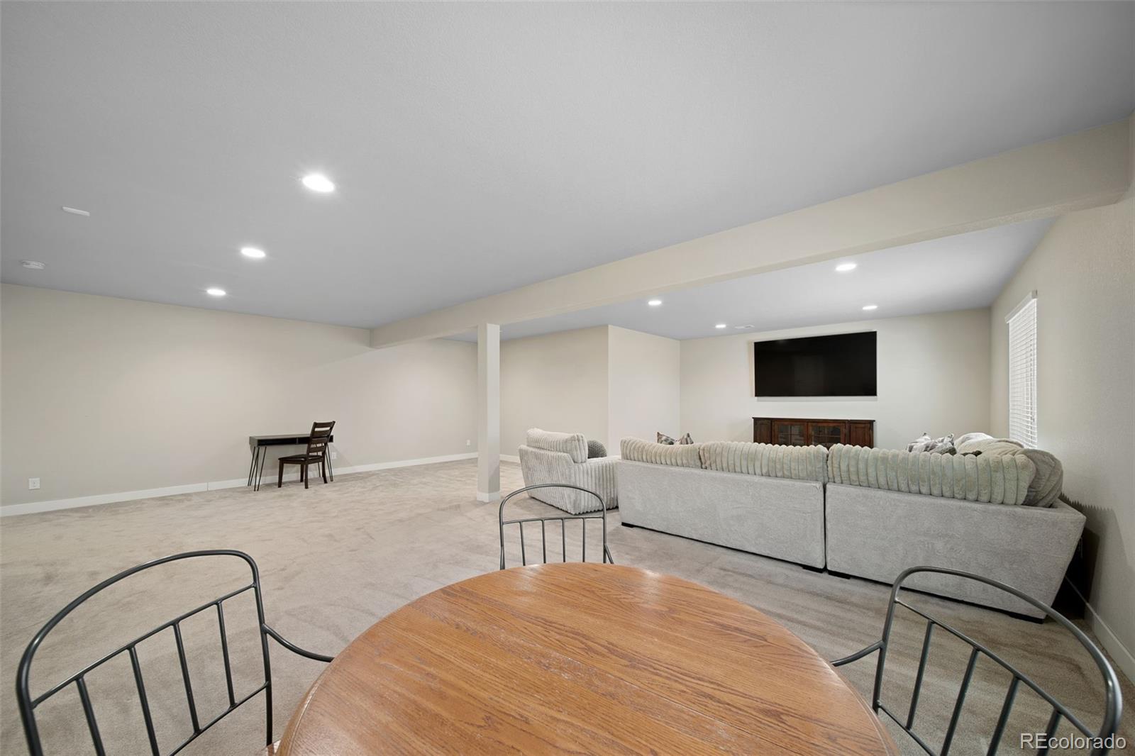 17670 West 94th Drive Arvada, CO 80007 - Photo 36 of 49 a living room with furniture and a flat screen tv