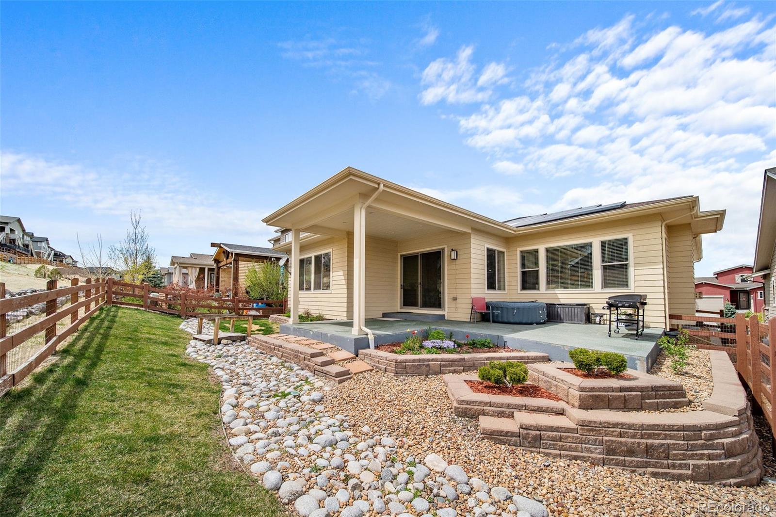17670 West 94th Drive Arvada, CO 80007 - Photo 4 of 49 a house view with a sitting space fire pit and outdoor space