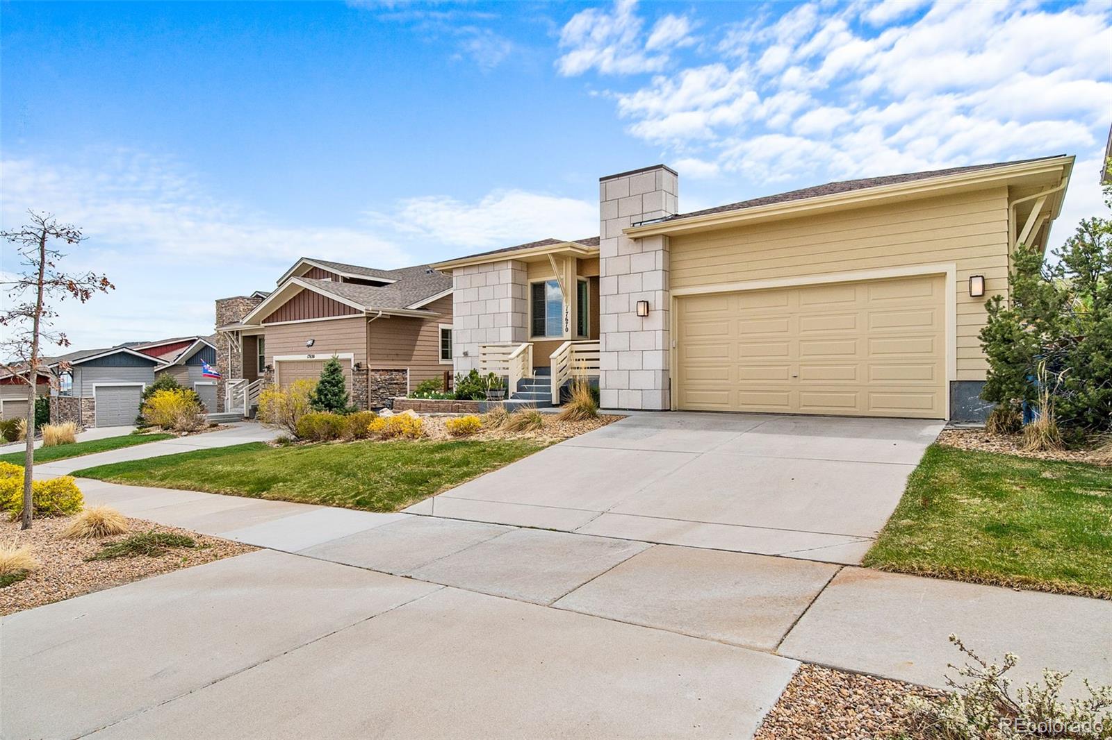 17670 West 94th Drive Arvada, CO 80007 - Photo 46 of 49 a front view of a house with a garden and plants