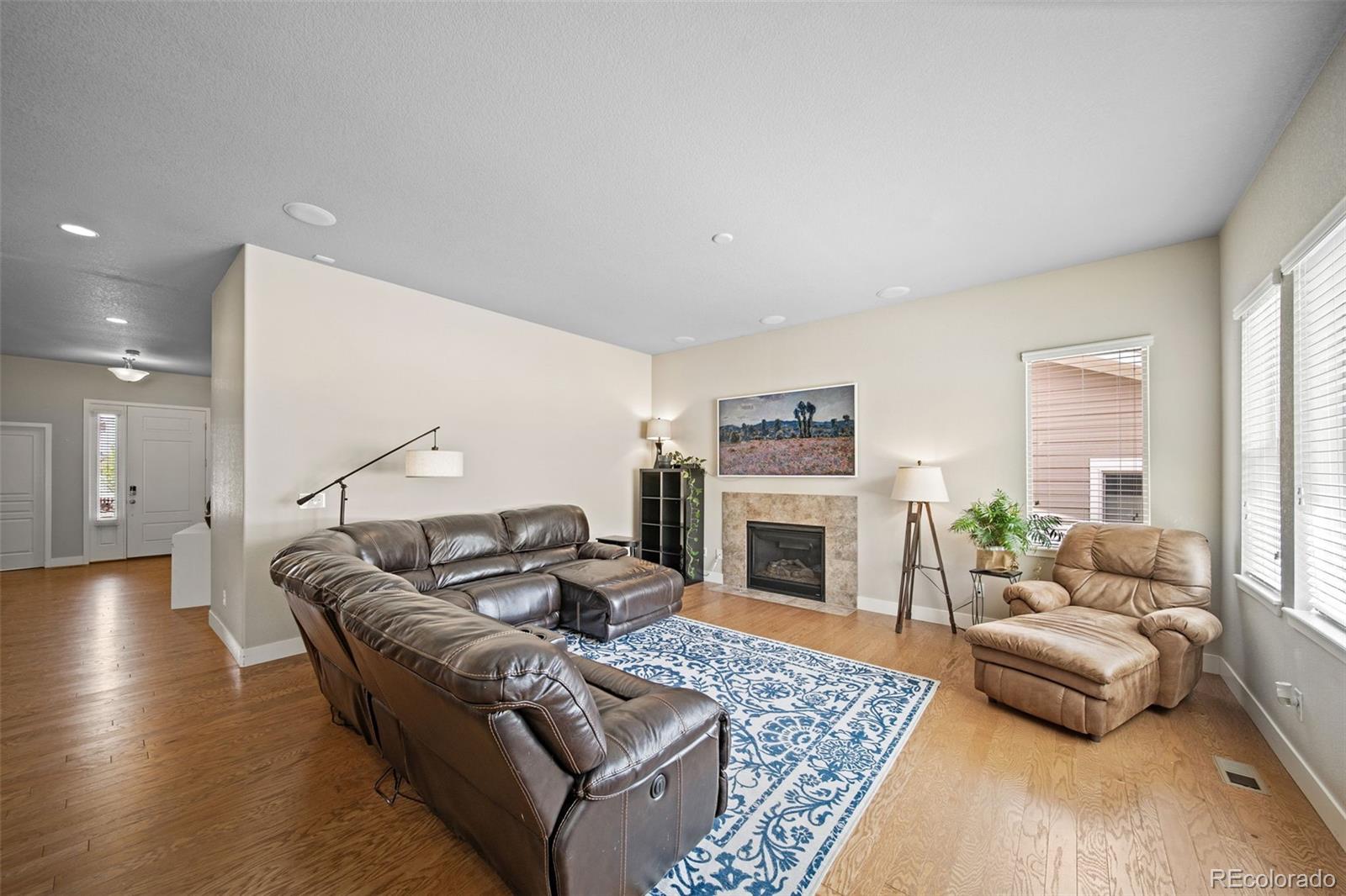 17670 West 94th Drive Arvada, CO 80007 - Photo 9 of 49 a living room with furniture and a fireplace