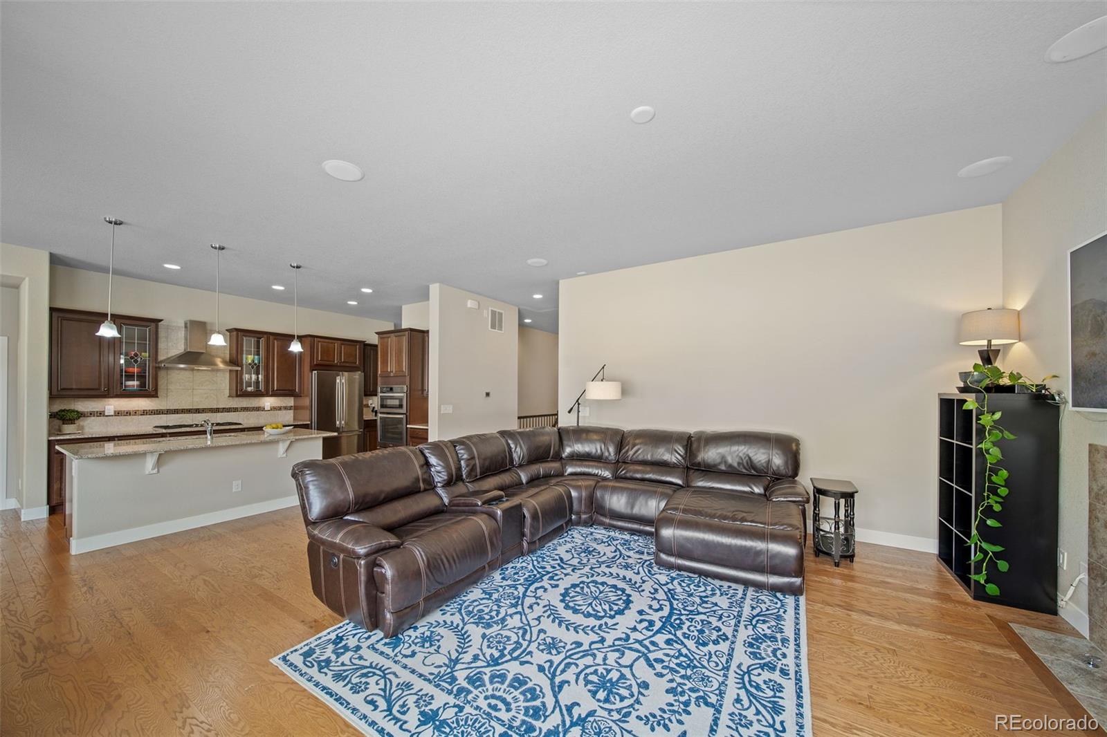 17670 West 94th Drive Arvada, CO 80007 - Photo 10 of 49 a living room with furniture and wooden floor