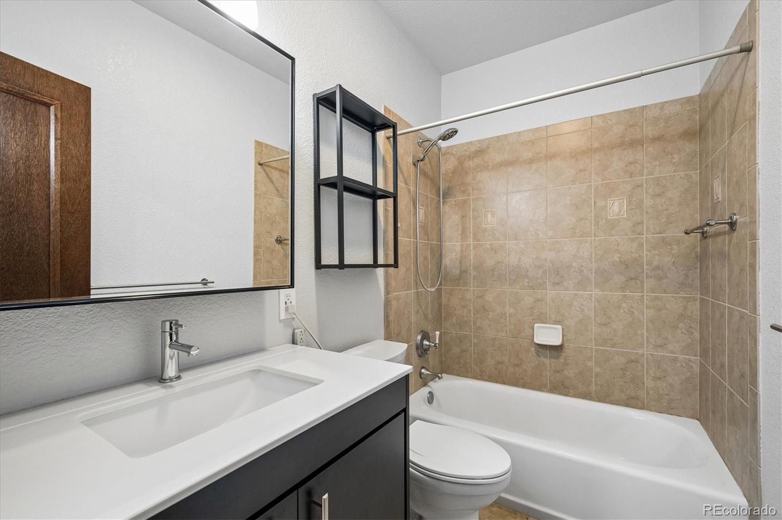 6747 South Brook Forest Road Evergreen, CO 80439 - Photo 33 of 49 a bathroom with a sink a toilet and a bathtub