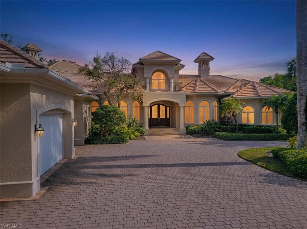 1269 Pocantico Lane Naples, FL 34110 - Photo 1 of 45 a front view of a house with garden