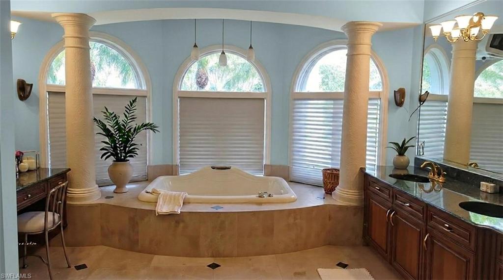 1269 Pocantico Lane Naples, FL 34110 - Photo 13 of 45 a bath tub sitting in a bathroom next to a window