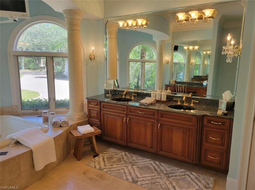 1269 Pocantico Lane Naples, FL 34110 - Photo 14 of 45 a large bathroom with a large window and a sink