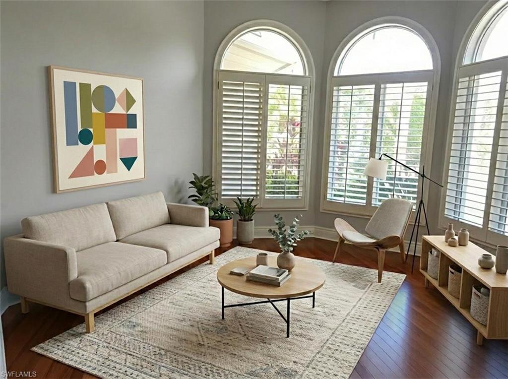 1269 Pocantico Lane Naples, FL 34110 - Photo 15 of 45 a living room with a couch wooden floor and a large window