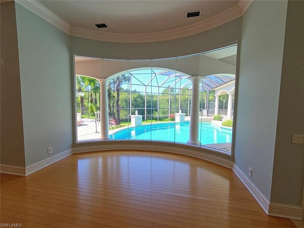 1269 Pocantico Lane Naples, FL 34110 - Photo 19 of 45 a view of empty room with wooden floor and fan