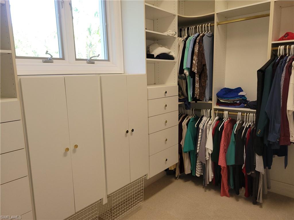 1269 Pocantico Lane Naples, FL 34110 - Photo 32 of 45 a view of walk in closet with clothes and shoes