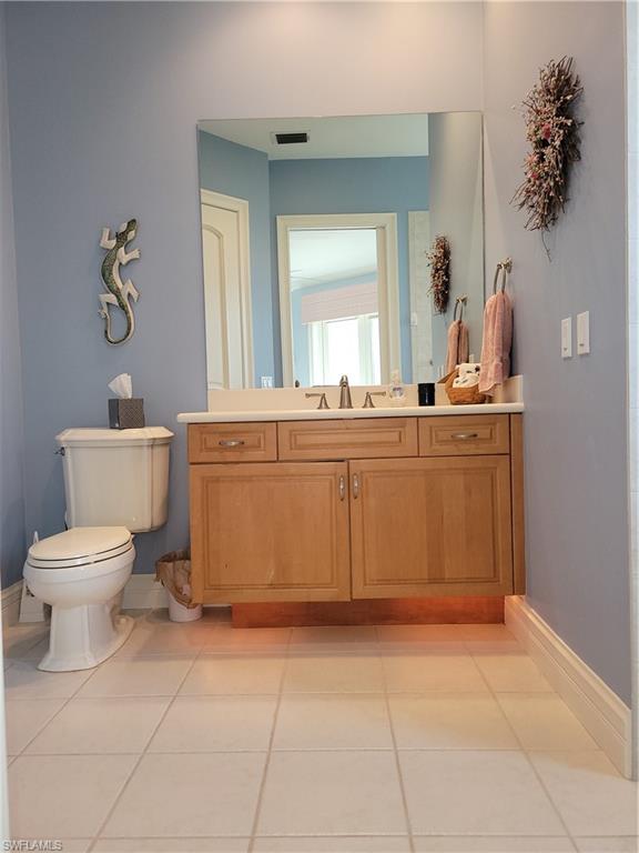 1269 Pocantico Lane Naples, FL 34110 - Photo 33 of 45 a spacious bathroom with a toilet sink and mirror