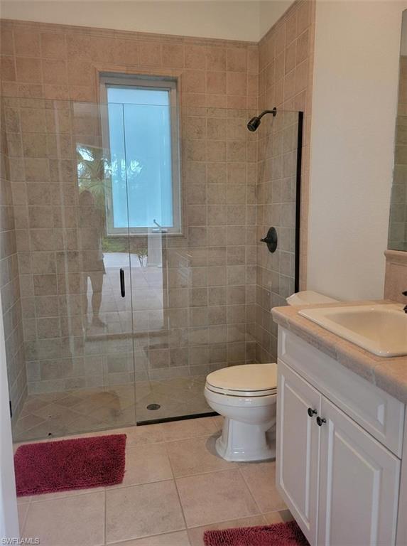 1269 Pocantico Lane Naples, FL 34110 - Photo 34 of 45 a bathroom with a sink a toilet and shower