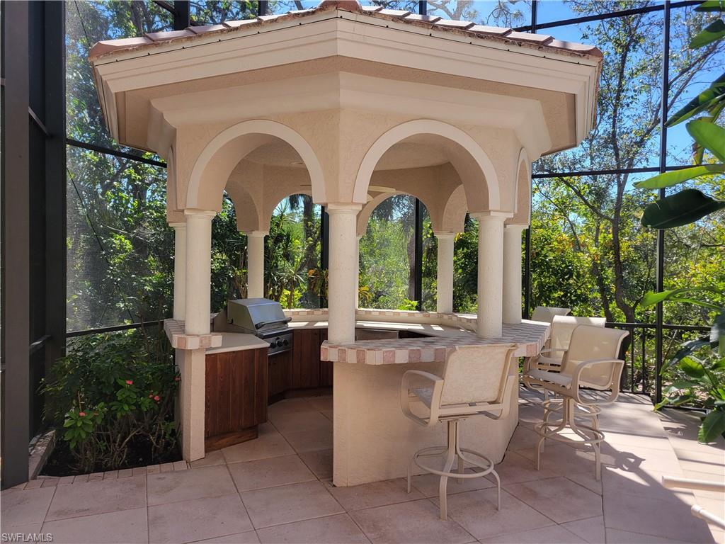 1269 Pocantico Lane Naples, FL 34110 - Photo 35 of 45 a view of a chairs and tables in the patio