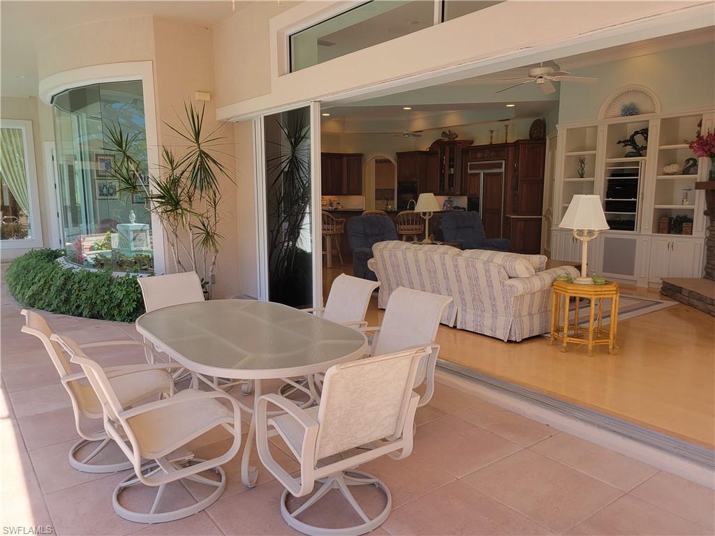 1269 Pocantico Lane Naples, FL 34110 - Photo 37 of 45 a dining room with furniture and wooden floor