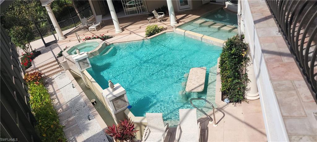 1269 Pocantico Lane Naples, FL 34110 - Photo 39 of 45 a view of swimming pool with a garden and plants