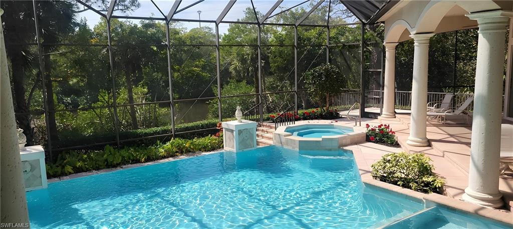 1269 Pocantico Lane Naples, FL 34110 - Photo 42 of 45 a view of a chair and tables in the garden